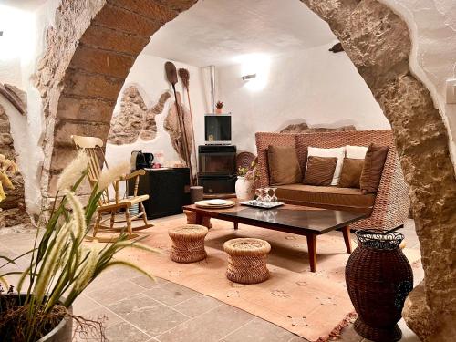 a living room with a couch and a table at Casa Maria - Charme nel cuore del castello in Castelsardo