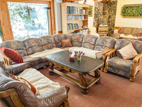 a living room with a couch and a table at Penzion Limba in Belá