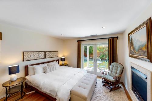 a bedroom with a large bed and a fireplace at Manchester Escape in Santa Barbara