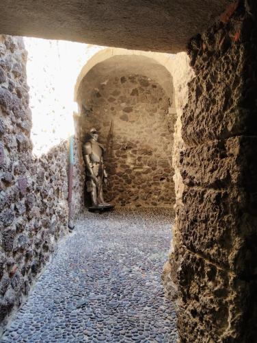 a statue of a horse in a stone tunnel at Casa Maria - Charme nel cuore del castello in Castelsardo