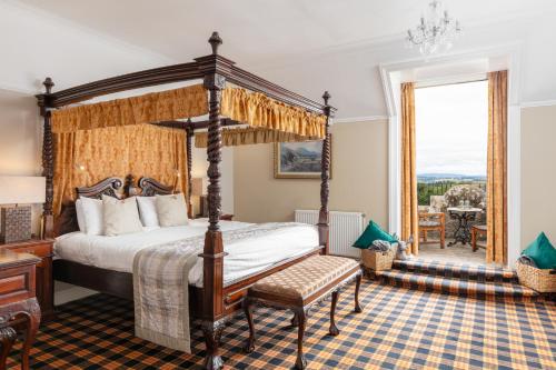 a bedroom with a four poster bed and a window at Tulloch Castle Hotel &lsquo;A Bespoke Hotel&rsquo; in Dingwall