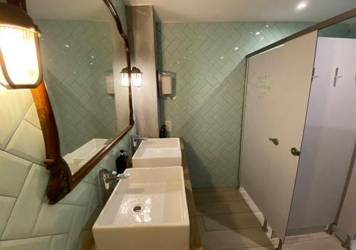 a bathroom with two sinks and a mirror at Blai Blai Hostel in Zarautz