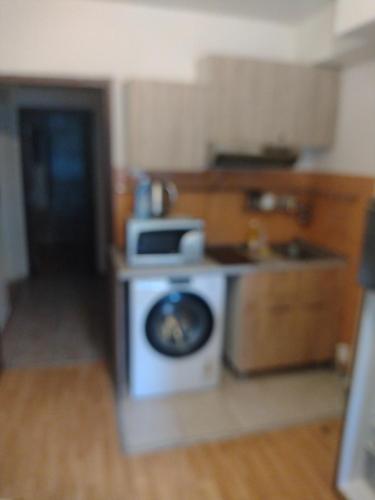 a kitchen with a stove top oven in a room at Апартмент Паисий 15 in Varna City