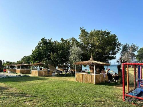a park with a group of tables and umbrellas at Kumburgaz Sahilde, Sitede, Konforlu, Manzaralı Klimalı Daire in Buyukcekmece