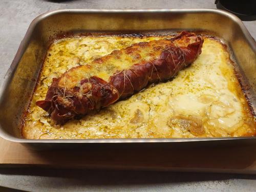 a pan of food with a piece of meat in it at Chambre d'hôtes Chalet AILLEURS in Molines-en-Queyras