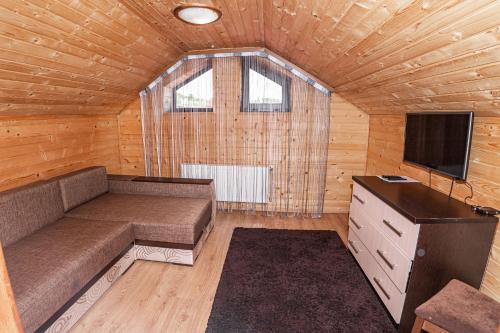a small living room with a couch and a television at Готель Чарда in Bukovel