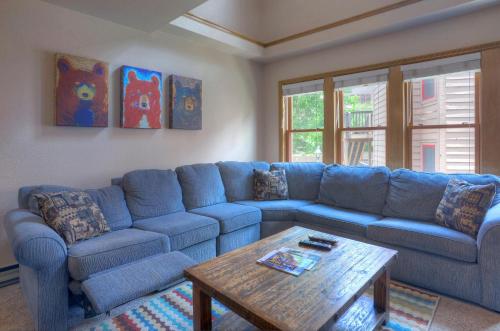 a living room with a blue couch and a coffee table at 2 2 Ferringway 9 in Durango