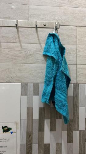 a blue towel is hanging on a wall at Home Feeling Kilimanjaro in Moshi