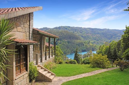 a house with a view of a river and mountains at Casa do Cadaval in Rio Caldo