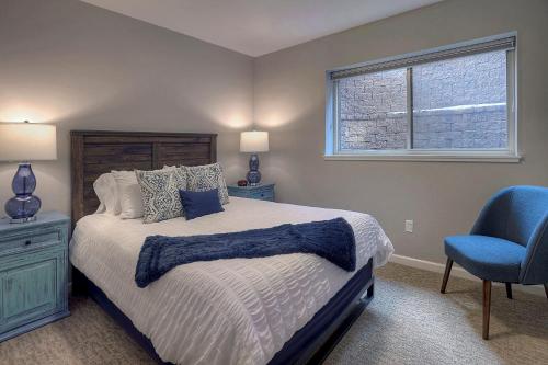 a bedroom with a bed and a blue chair at 572 E 3rd Avenue in Durango