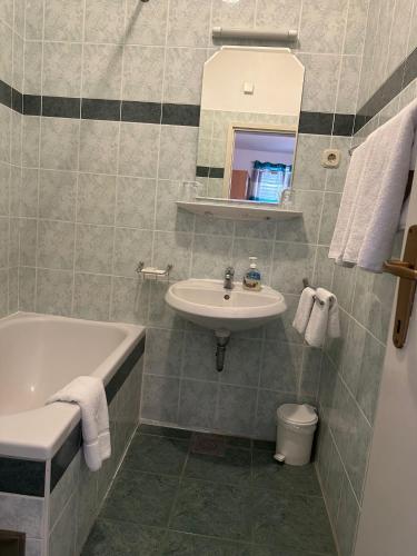 a bathroom with a sink and a toilet and a tub at Longa Rooms in Šibenik