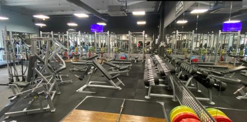 a gym with rows of machines in a room at February Bliss Special, Unwind in Style with Our Exclusive SA PROMO, BOOK NOW in Woolwich
