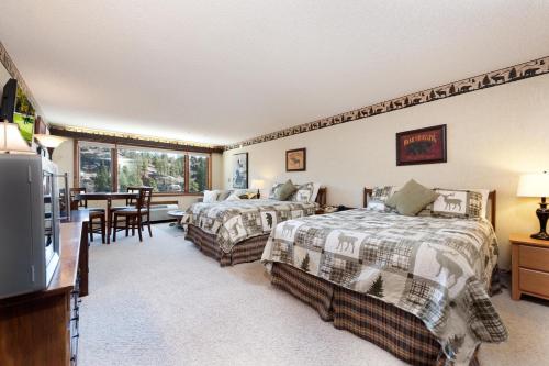 1 dormitorio con 2 camas y comedor en Tamarron Lodge Studio 236, en Durango