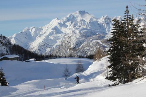 a person is skiing down a snow covered mountain at ValmalencoAlpina in Caspoggio