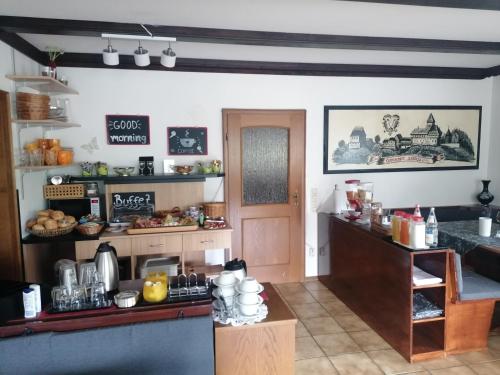 a kitchen with a counter and a table with food at Haus Schwarzwaldblick in Hornberg