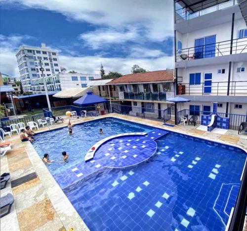 a large swimming pool with people in the water at HOTEL BELLA PAMPA FUSAGASUGA in Fusagasuga