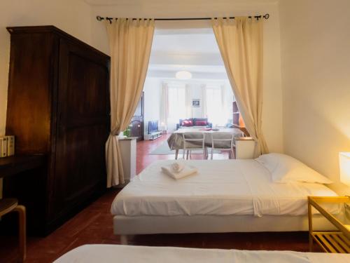 a bedroom with two beds and a dining room at Old Town- 4 Pers, Vieux Nice, AC, wifi in Nice