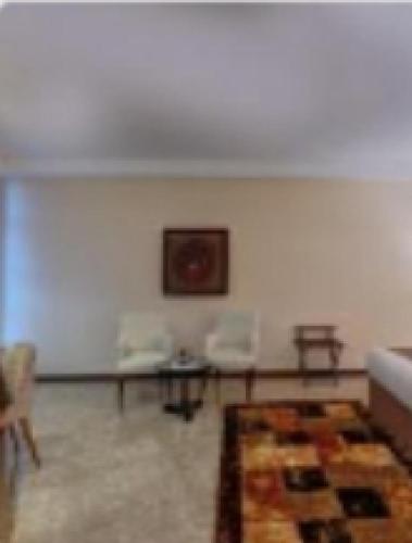 a living room with a couch and a table at Aryana Hotel in Sharjah
