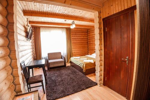 a small room with a door and a bedroom at Готель Чарда in Bukovel