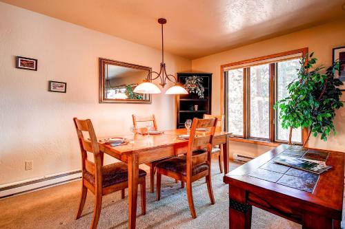 a dining room with a wooden table and chairs at Beautiful Townhome Short Walk to Slopes and Town - LW01 in Breckenridge