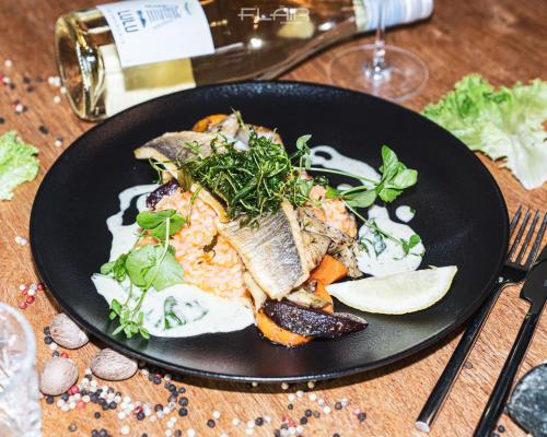 a plate of food with fish and vegetables on a table at AiREA Hotel in Büren
