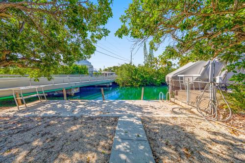 a bridge over a body of water with trees at Yellowtail House in Marathon