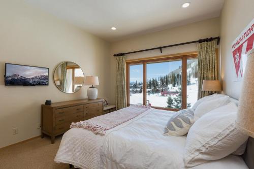 a bedroom with a large bed and a window at Village Center 611 in Durango Mountain Resort