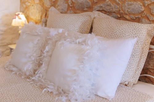 two white pillows sitting on top of a bed at Iliana's house - spacious cave house in the center of Areopolis in Areopolis