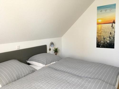 two beds sitting next to each other in a bedroom at Seehaus Luddenhof 1 - a90196 in Walchum