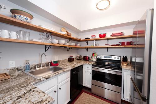 a kitchen with a sink and a stove at Pine Acres - Unit 115 in Durango
