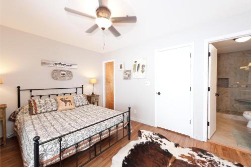 a bedroom with a bed and a ceiling fan at Pine Acres - Unit 115 in Durango