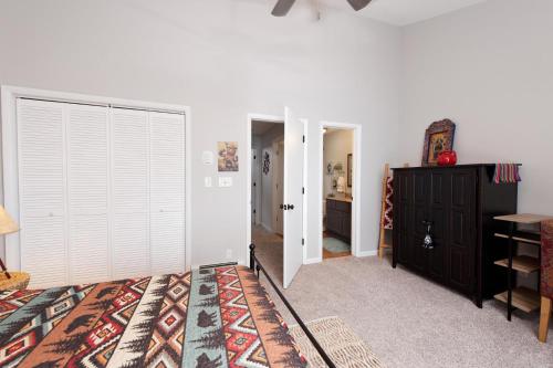 a bedroom with a bed and a closet at Pine Acres - Unit 115 in Durango