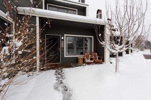 a house in the snow with two chairs at Pine Acres - Unit 115 in Durango