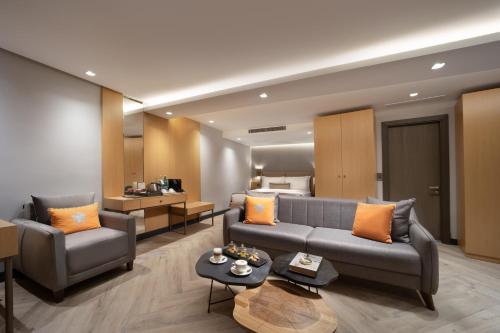 a living room with two couches and a bed at Motto By Mula Hotel in Istanbul