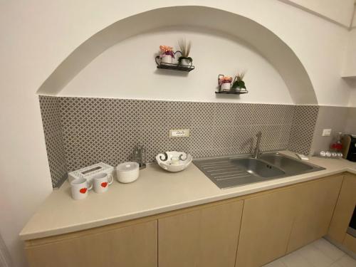 a kitchen with a sink and a counter top at Nonna Lenuccia in Noci