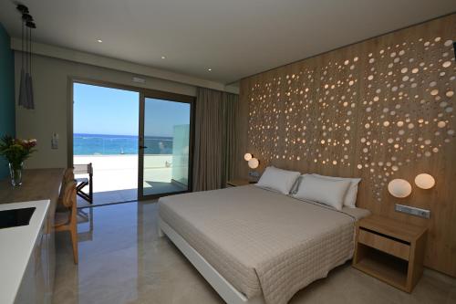 a bedroom with a bed and a wall with lights at Blue Sky Hotel Apartments in Rethymno