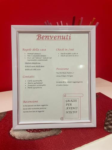un menú enmarcado para un restaurante en una mesa roja en Il Nido Rosso, en Foligno