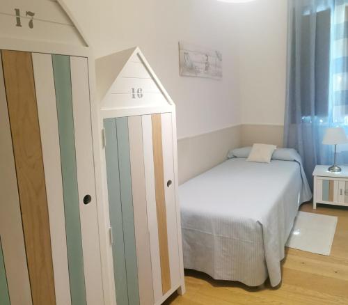 a small bedroom with a bed and a crib at Il gelsomino in Fano