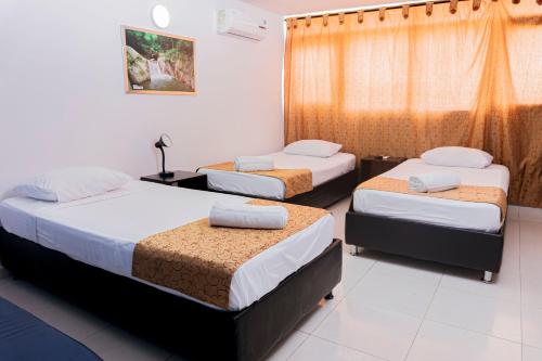 Letto o letti in una camera di Hotel Sol Inn Santa Marta