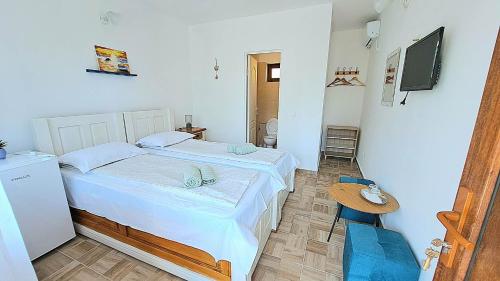 a small bedroom with a bed and a table at Casa Gabriela in Vama Veche