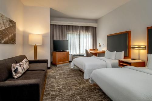 a hotel room with two beds and a couch at SpringHill Suites by Marriott Hershey Near The Park in Hershey
