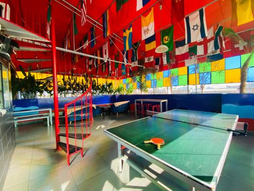 a ping pong table in a room with colorful walls at Ica Adventures II in Ica