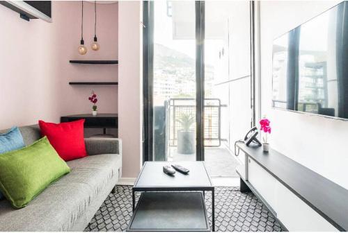 a living room with a couch and a table at Sweet Flamingo in Cape Town