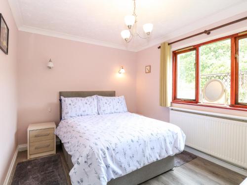 a bedroom with a bed and a window at Deer Cottage in Thompson