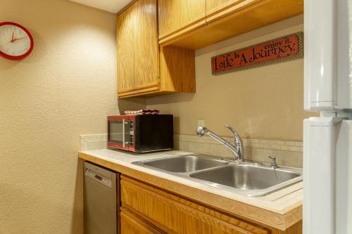 a kitchen with a sink and a microwave at Cascade Village 301 in Durango Mountain Resort
