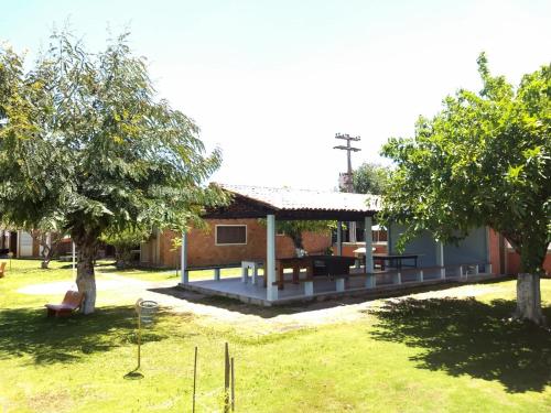 a house with a picnic table and a church at Praia dos Carneiros in Tamandaré