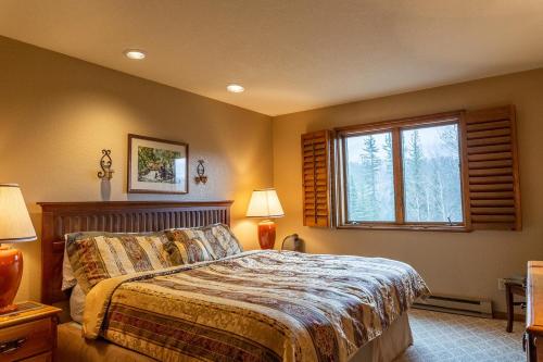 a bedroom with a bed and a window at Cascade Village 301 in Durango Mountain Resort