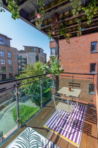 a deck with a table and a bench on a balcony at GuestReady - Modern stay by Pheonix Park in Dublin