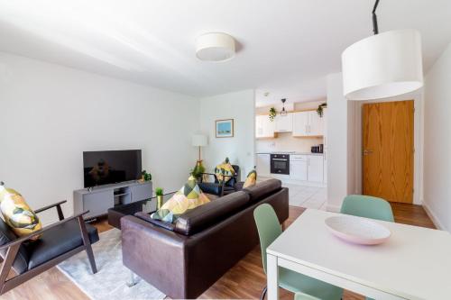 a living room with a couch and a table at GuestReady - Modern stay by Pheonix Park in Dublin
