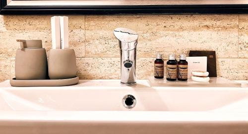 a white sink with a hair drier on top of it at Excelsior INN in Turda